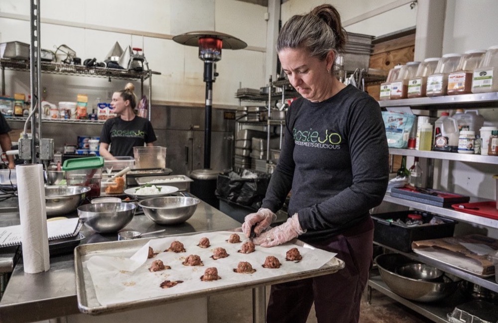 Chef Katie Shull preparing a tray of meatballs in the RosieJo kitchen